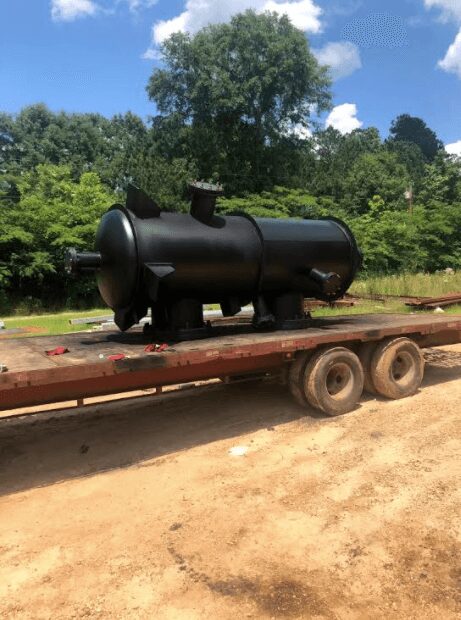 A large black tank sitting on top of a trailer.